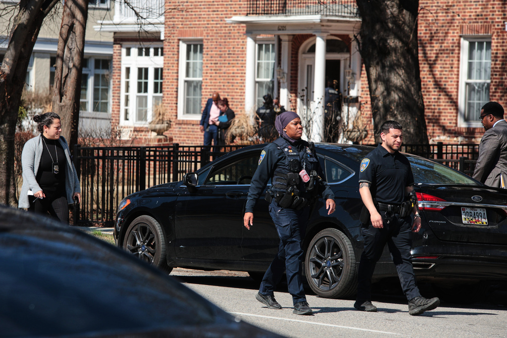 Baltimore Police officers are seen near the scene of a shooting Tuesday, March 10, 2026, in Baltimore. (AP Photo/KT Kanazawich)