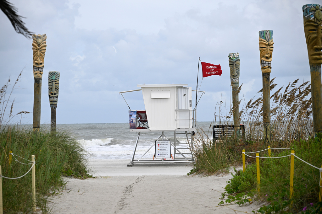 FILE - A "Danger Rip Current" flag flies as Tropical Storm Imelda passes offshore Sept. 29, 2025, in Cocoa Beach, Fla. (AP Photo/Phelan M. Ebenhack, File)