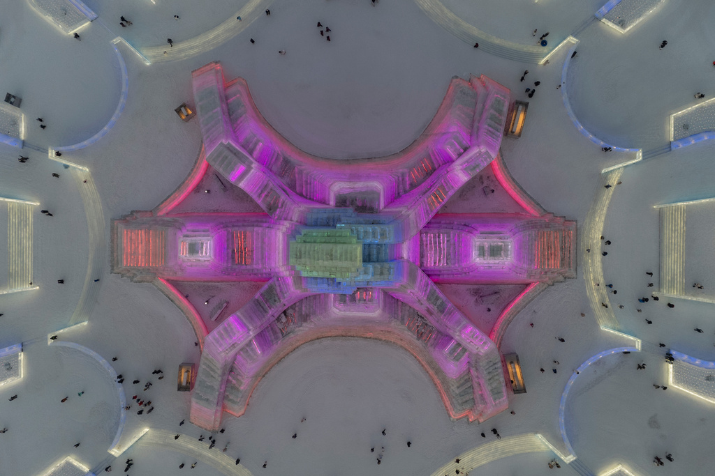 Attendees take in the sights at the annual Ice and Snow Festival held in Harbin in northeastern China's Heilongjiang province, Saturday, Jan. 3, 2026. (AP Photo/Ng Han Guan)