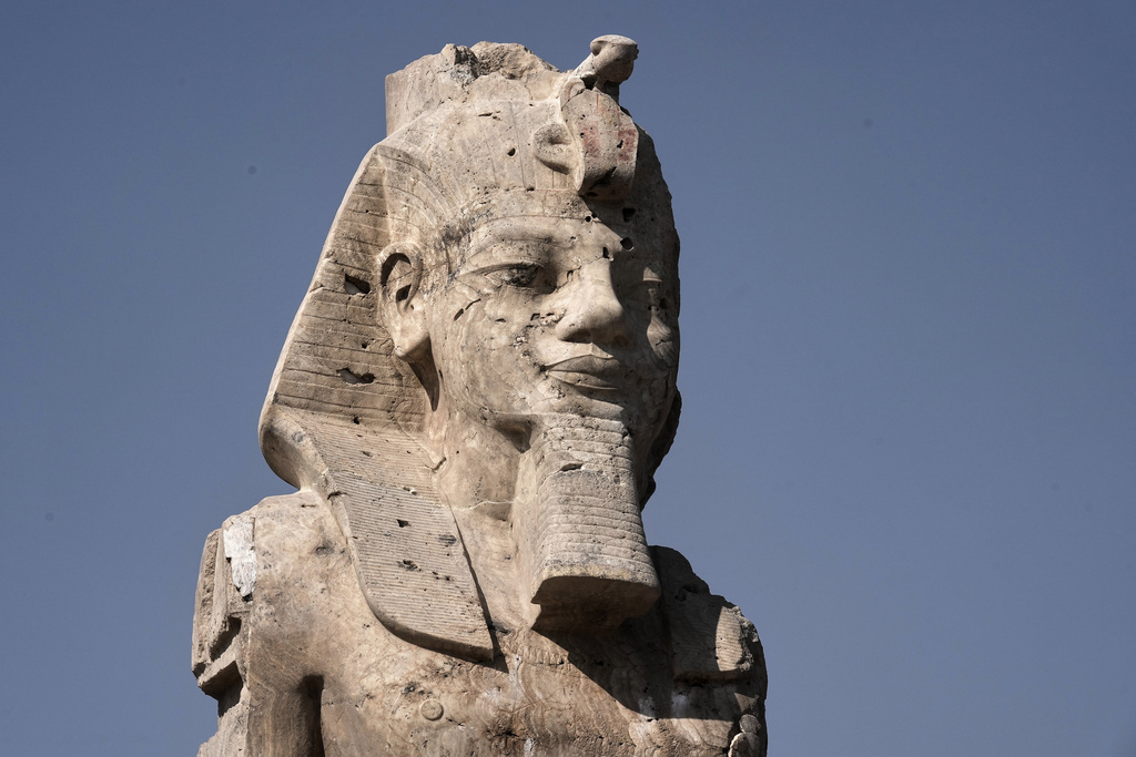 One of the two giant alabaster statues of Pharoah Amenhotep III, is photographed during the official opening, in the southern city of Luxor, Egypt, Sunday, Dec. 14, 2025. (AP Photo/Amr Nabil)
