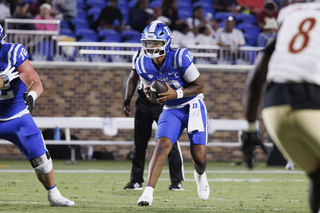 Duke's Darian Mensah (10) takes a snap during the first half of an NCAA college football game against Elon in Durham, N.C., Thursday, Aug. 28, 2025. (AP Photo/Ben McKeown)