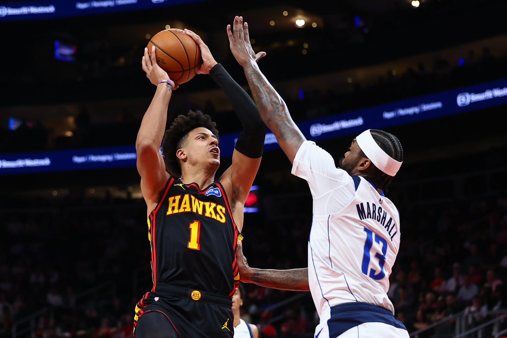 Atlanta Hawks forward Jalen Johnson (1) shoots against Dallas Mavericks forward Naji Marshall (13) during the first half of an NBA basketball game, Tuesday, March 10, 2026, in Atlanta. (AP Photo/Colin Hubbard)