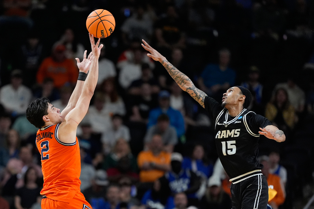 Illinois guard Andrej Stojakovic (2) shoots and scores against Virginia Commonwealth guard Tyrell Ward (15) during the first half in the second round of the NCAA college basketball tournament, Saturday, March 21, 2026, in Greenville, S.C. (AP Photo/Brynn Anderson)