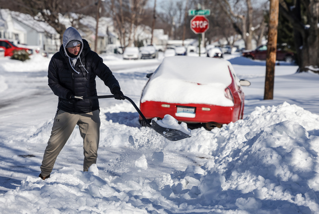 Keaton Fitzgerald uses a snow shovel to dig out of his driveway, Monday, Jan. 26, 2026, in Owensboro, Ky. (Greg Eans/The Messenger-Inquirer via AP)