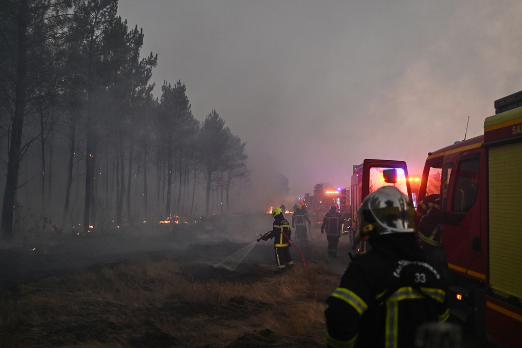 Firefighters battle a wildfire near Marcheprime, outside, Bordeaux, France, Sunday, July 26, 2026. (AP Photo/Emma Da Silva)