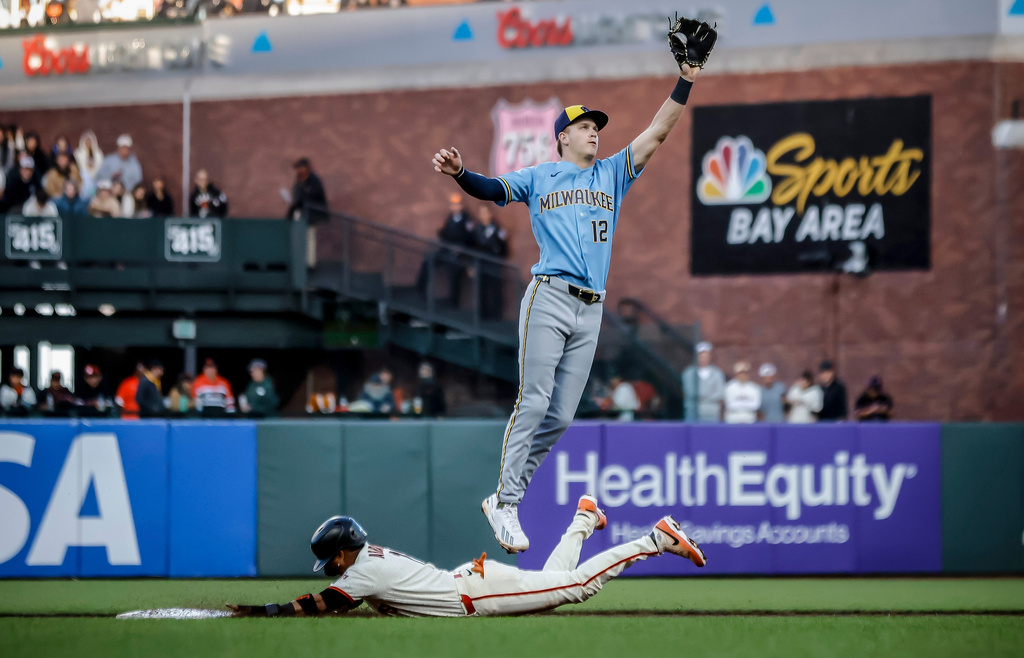 San Francisco Giants' Luis Arraez steals second as Milwaukee Brewers' Cooper Pratt (12) leaps for a high throw from the catcher during the third inning of a baseball game in San Francisco, Monday, July 27, 2026. (Carlos Avila Gonzalez/San Francisco Chronicle via AP)