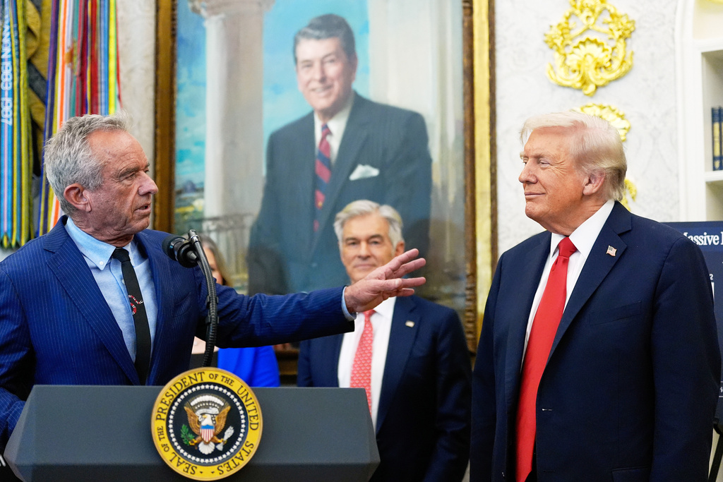 FILE - President Donald Trump listens as Health and Human Services Secretary Robert F. Kennedy Jr., speaks in the Oval Office of the White House, Oct. 16, 2025, in Washington. (AP Photo/Alex Brandon, File)
