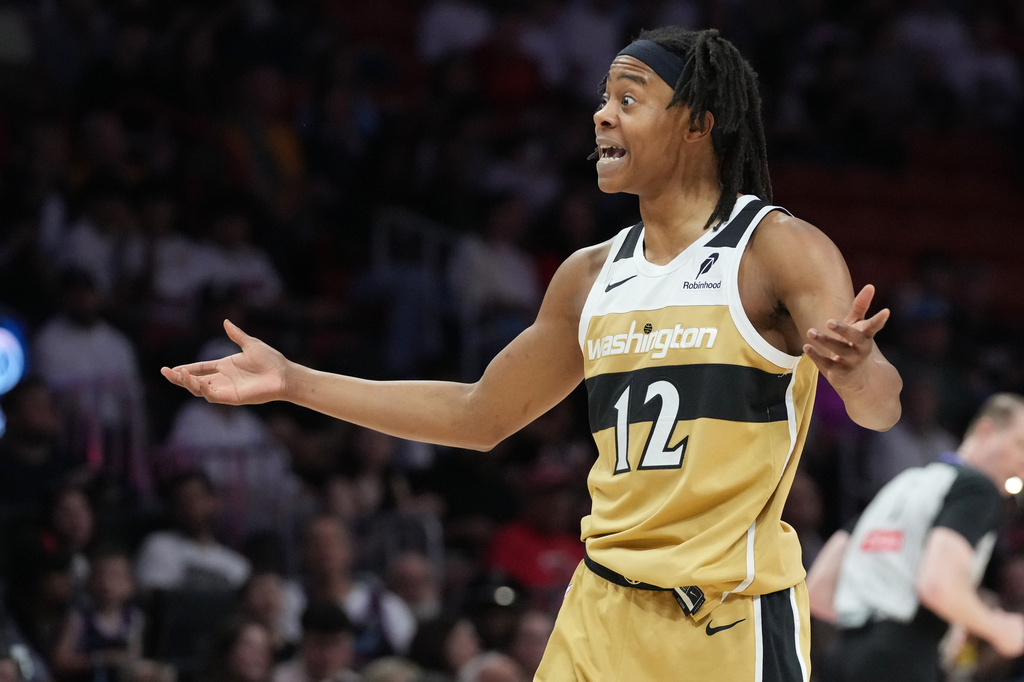 Washington Wizards guard Tre Johnson (12) reacts to a call during the first half of an NBA basketball game against the Miami Heat Saturday, April 4, 2026, in Miami. (AP Photo/Marta Lavandier)
