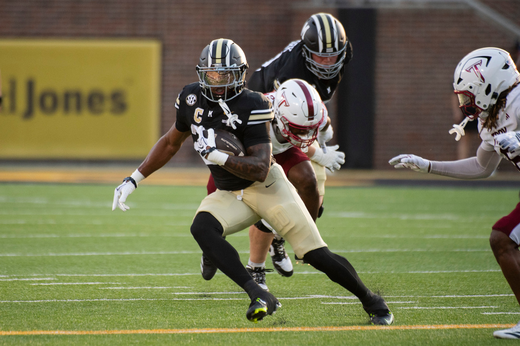 Missouri running back Jamal Roberts, front left, run the ball during the first half of an NCAA college football game against Troy, Saturday, Sept. 19, 2026, in Columbia, Mo. (AP Photo/LG Patterson)