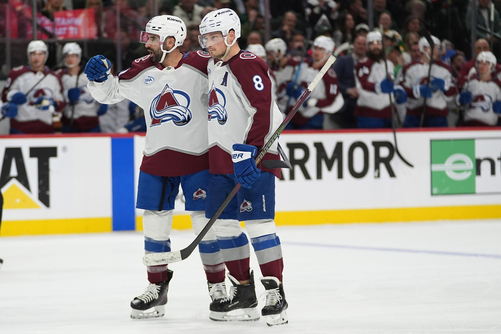 Colorado Avalanche center Nazem Kadri (91), left, celebrates with defenseman Cale Makar (8) after scoring a goal during the second period of Game 4 in an NHL Stanley Cup hockey second-round playoff series against the Minnesota Wild Monday, May 11, 2026, in St. Paul, Minn. (AP Photo/Abbie Parr)