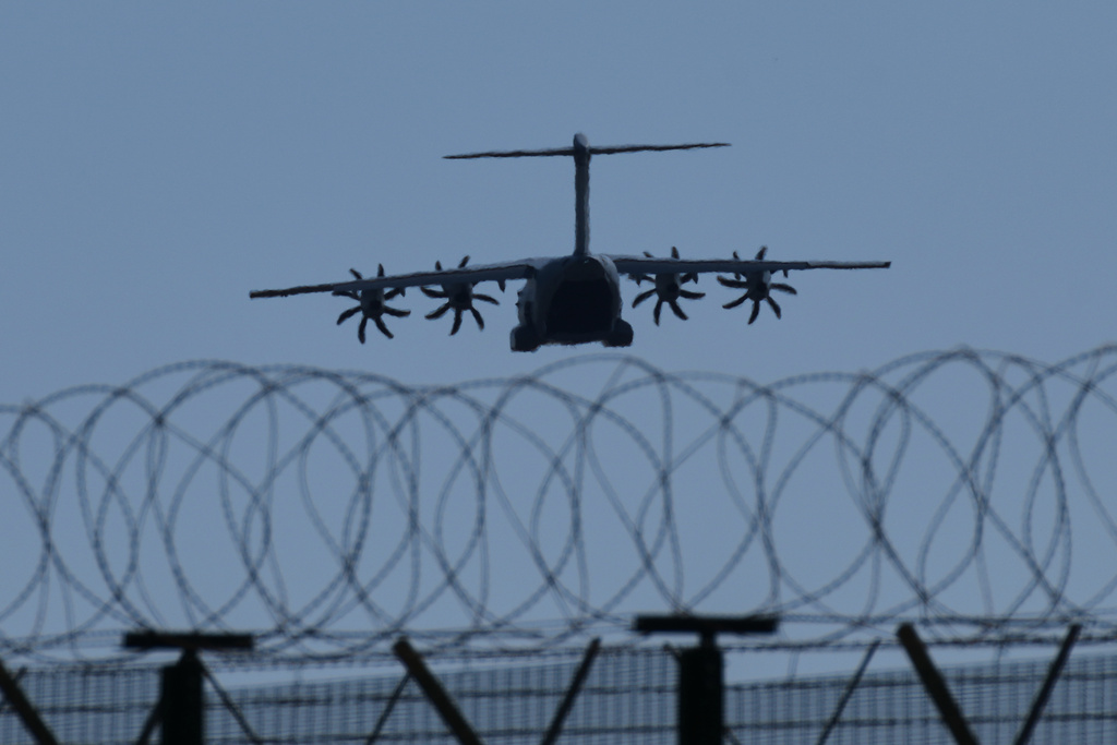 A transport aircraft prepares for landing at U.K.'s RAF Akrotiri air base near Limassol, Cyprus, Tuesday, March, 3, 2026. (AP Photo/Petros Karadjias)