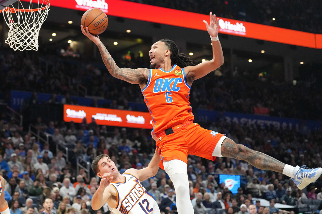 Oklahoma City Thunder forward Jaylin Williams (8) shoots over Phoenix Suns guard Collin Gillespie (12) during the second half of an NBA Cup basketball game, Friday, Nov. 28, 2025, in Oklahoma City. (AP Photo/Kyle Phillips)