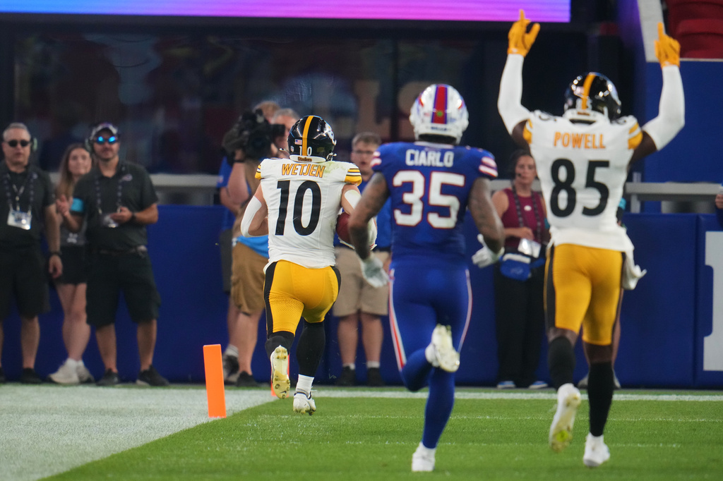 Pittsburgh Steelers wide receiver Kaden Wetjen (10) returns a punt for a touchdown as Buffalo Bills' Jimmy Ciarlo (35) and Cornell Powell (85) look on in the second half of a preseason NFL football game in Orchard Park, NY., Thursday, Aug. 27, 2026. (AP Photo/Gene J. Puskar)
