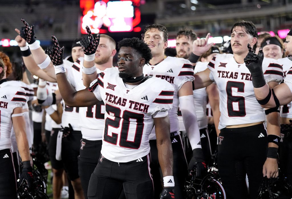 Texas Tech running back J'Koby Williams (20) joins teammates in singing their fight song as they celebrate after their win over Houston in an NCAA college football game, Saturday, Oct. 4, 2025, in Houston. (AP Photo/Karen Warren)