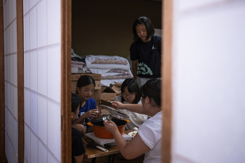 Wrestlers prepare dinner after a practice session at a sumo camp in Tottori Johoku High School in Tottori, Japan, on July 28, 2025. (AP Photo/Louise Delmotte)