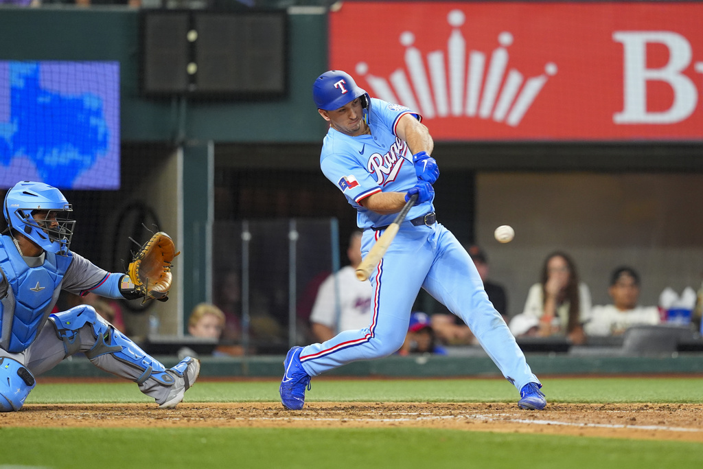 Texas Rangers Wyatt Langford hits a solo home run during the sixth inning of a baseball game against the Miami Marlins on Sunday, Sept. 21, 2025, in Arlington, Texas. (AP Photo/Ronaldo Bolaños)