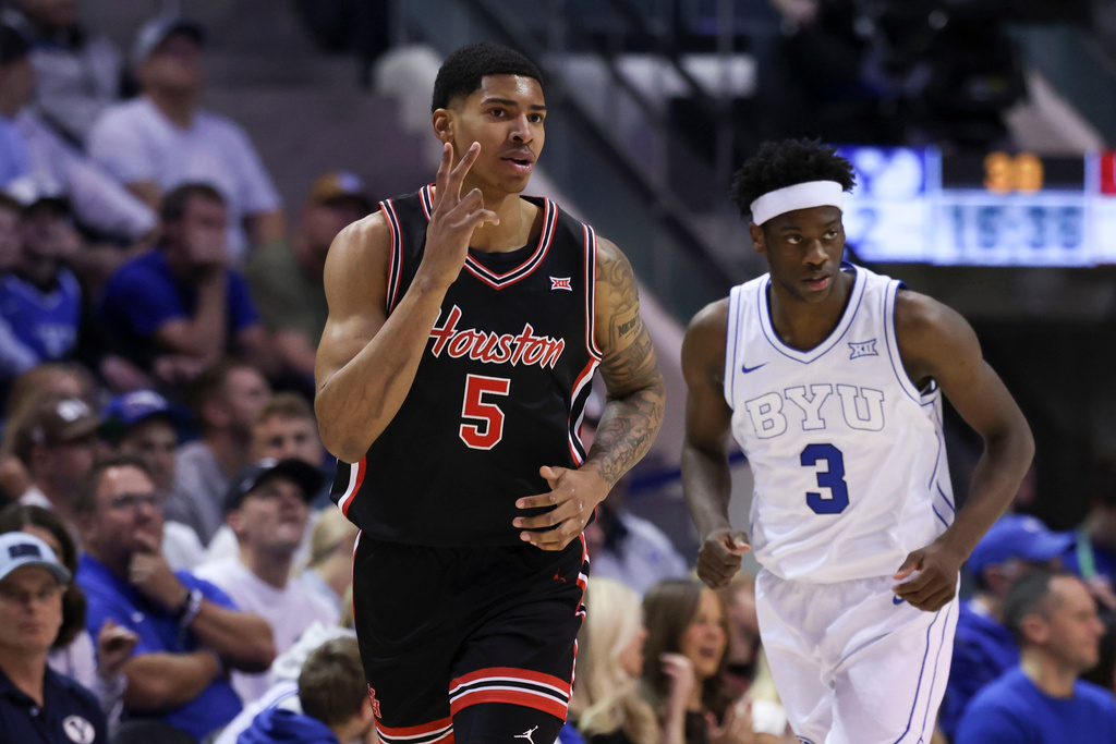 Houston center Chris Cenac Jr. (5) reacts after a three point basket against BYU during the first half of an NCAA college basketball game, Saturday, Feb. 7, 2026, in Provo, Utah. (AP Photo/Rob Gray)