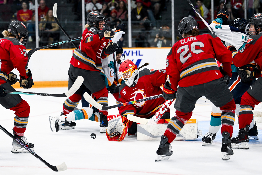 Ottawa Charge goaltender Gwyneth Philips, center, makes a save through traffic during second-period PWHL hockey game action against the New York Sirens in Ottawa, Ontario, Saturday, April 18, 2026. (Spencer Colby/The Canadian Press via AP)