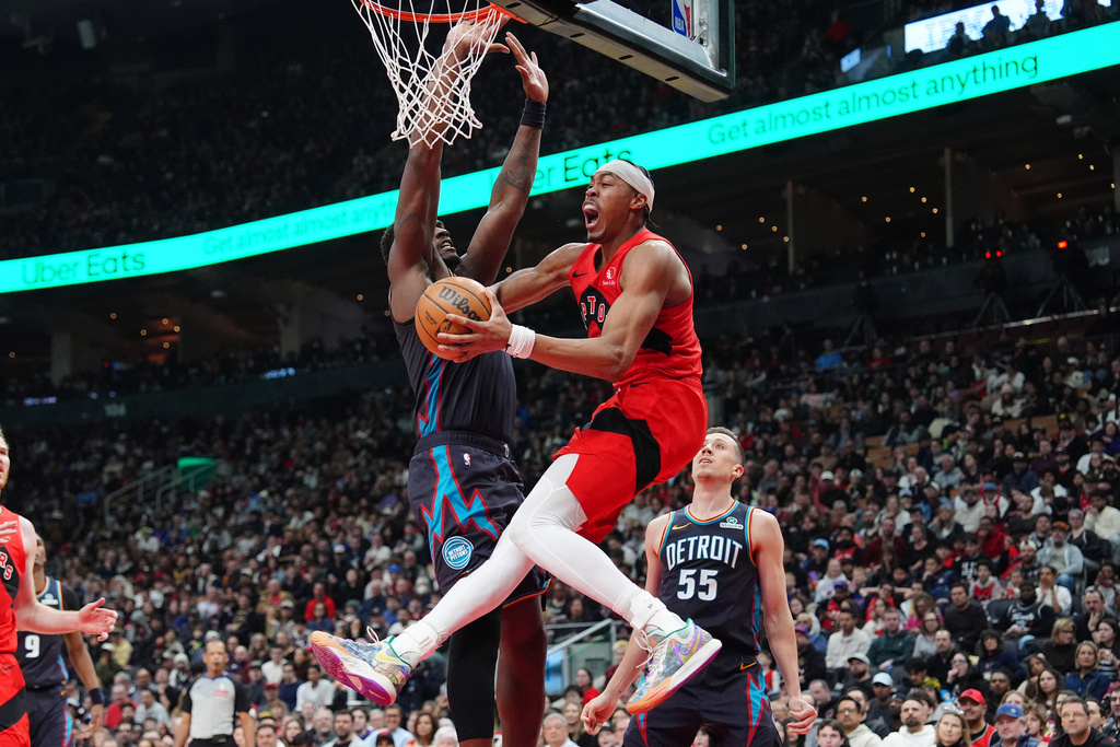Toronto Raptors forward Scottie Barnes, right, is fouled by Detroit Pistons center Jalen Duren as Barnes jumps for the hoop during the first half of an NBA basketball game in Toronto, Sunday, March 15, 2026. (Frank Gunn/The Canadian Press via AP)