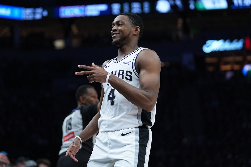 San Antonio Spurs guard De'aaron Fox (4) reacts after scoring against the Minnesota Timberwolves during the second half of Game 6 of an NBA basketball second-round playoffs series in Minneapolis, Friday, May 15, 2026. (AP Photo/Abbie Parr)