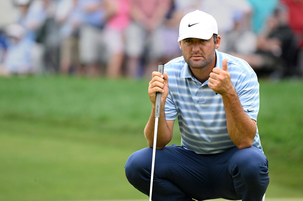 Scottie Scheffler gives a thumbs up to his caddie on the 9th hole during the second round of the Travelers Championship golf tournament at TPC River Highlands, Friday, June 26, 2026, in Cromwell, Conn. (AP Photo/Jessica Hill)