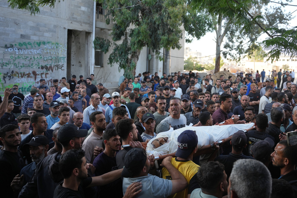 Mourners carry the body of Abdullah Qadoum, who was killed in an Israeli airstrike that targeted a tent housing Palestinians, during his funeral in Gaza City, Saturday, June 6, 2026. (AP Photo/Abdel Kareem Hana)