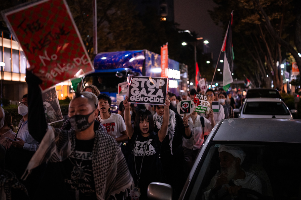 Demonstrators hold banners during a protest in support of Palestinians, in Tokyo, Tuesday, Oct 7, 2025. (AP Photo/Louise Delmotte)