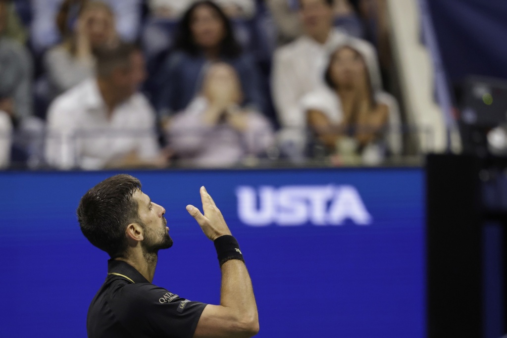 Novak Djokovic, of Serbia, blows kisses to the crowd after winning the second set against Taylor Fritz, of the United States, during the quarterfinal round of the U.S. Open tennis championships, Tuesday, Sept. 2, 2025, in New York. (AP Photo/Adam Hunger)