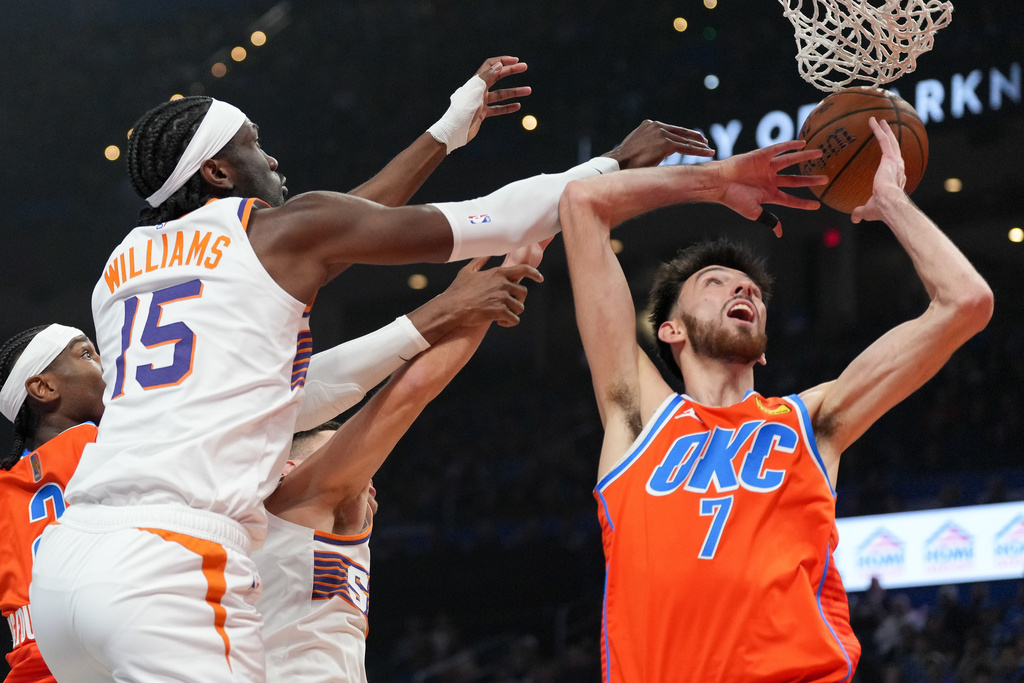 Phoenix Suns center Mark Williams (15) tries to get to a rebound before Oklahoma City Thunder center Chet Holmgren (7) during the first half of an NBA Cup basketball game, Wednesday, Dec. 10, 2025, in Oklahoma City. (AP Photo/Kyle Phillips)
