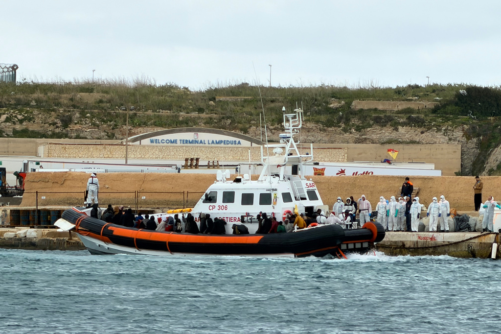 In this photo provided by Mediterranea Saving Humans, an Italian Coast Guard rescue boat at dock in the southern Italian island of Lampedusa, disembarks survivors and bodies rescued from a dinghy filled with migrants at about 80 nautical miles from the island of Lampedusa, Italy, Wednesday, April 1, 2026. (Mediterranea Saving Humans via AP)