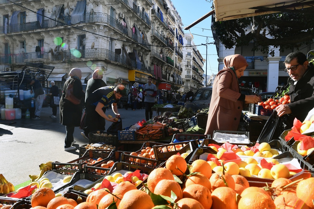 People stock up on food at a market in Algiers, Algeria, Thursday, Feb. 17, 2026, before the start of the holy month of Ramadan. (AP Photo/Fateh Guidoum)