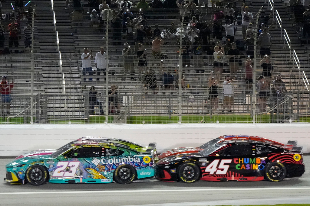 Bubba Wallace (23) and Tyler Reddick (45) run during a NASCAR Cup Series auto race, Sunday, July 12, 2026, in Hampton, Ga. (AP Photo/Mike Stewart)