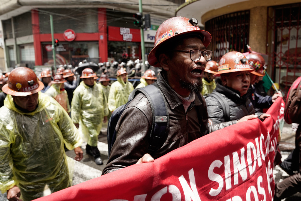 Miners march to protest President Rodrigo Paz's decision to remove fuel subsidies in La Paz, Bolivia, Friday, Dec. 26, 2025. (AP Photo/Freddy Barragan)