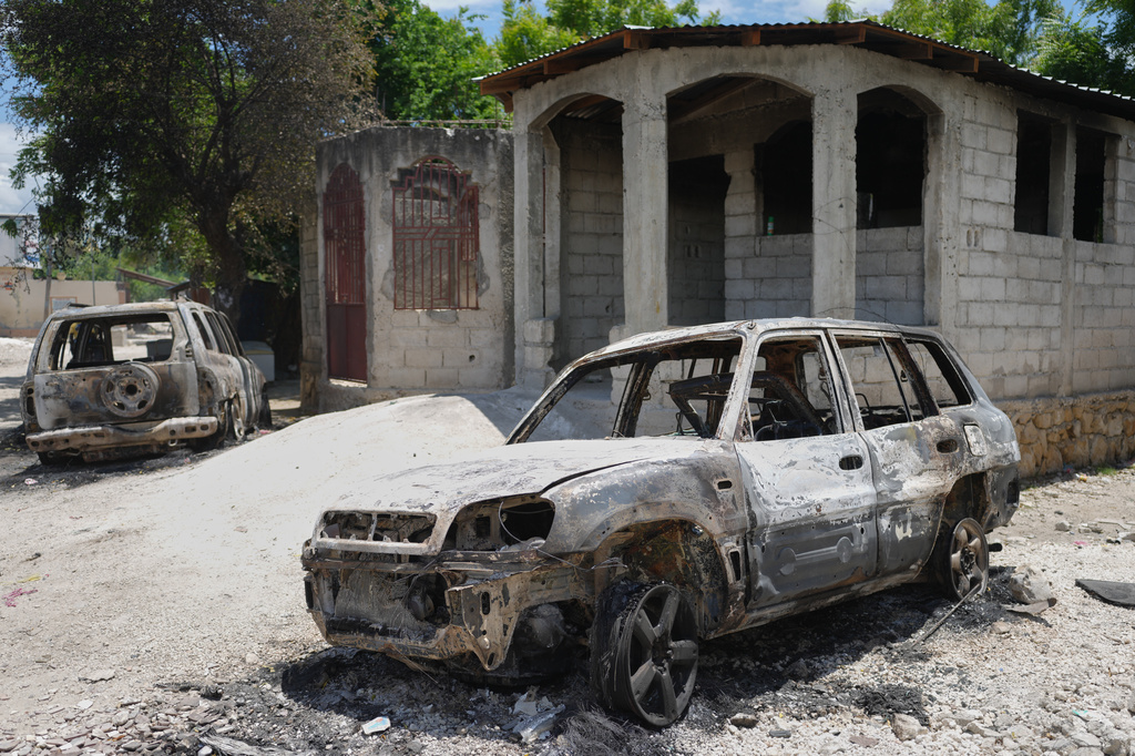 Vehicles that were set on fire by armed gangs sit in the Cite Soleil neighborhood of Port-au-Prince, Haiti, Tuesday, May 12, 2026. (AP Photo/Odelyn Joseph)
