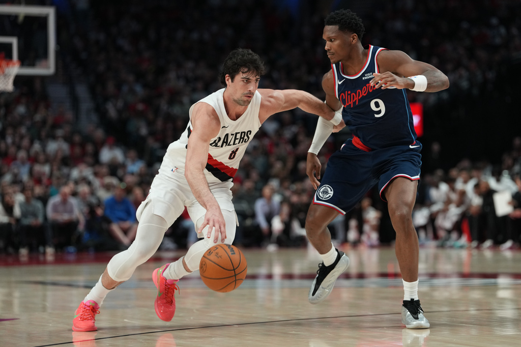 Portland Trail Blazers forward Deni Avdija (8) tries to get past Los Angeles Clippers guard/forward Bennedict Mathurin (9) during the first half of an NBA basketball game Friday, April 10, 2026, in Portland, Ore. (AP Photo/Jenny Kane)