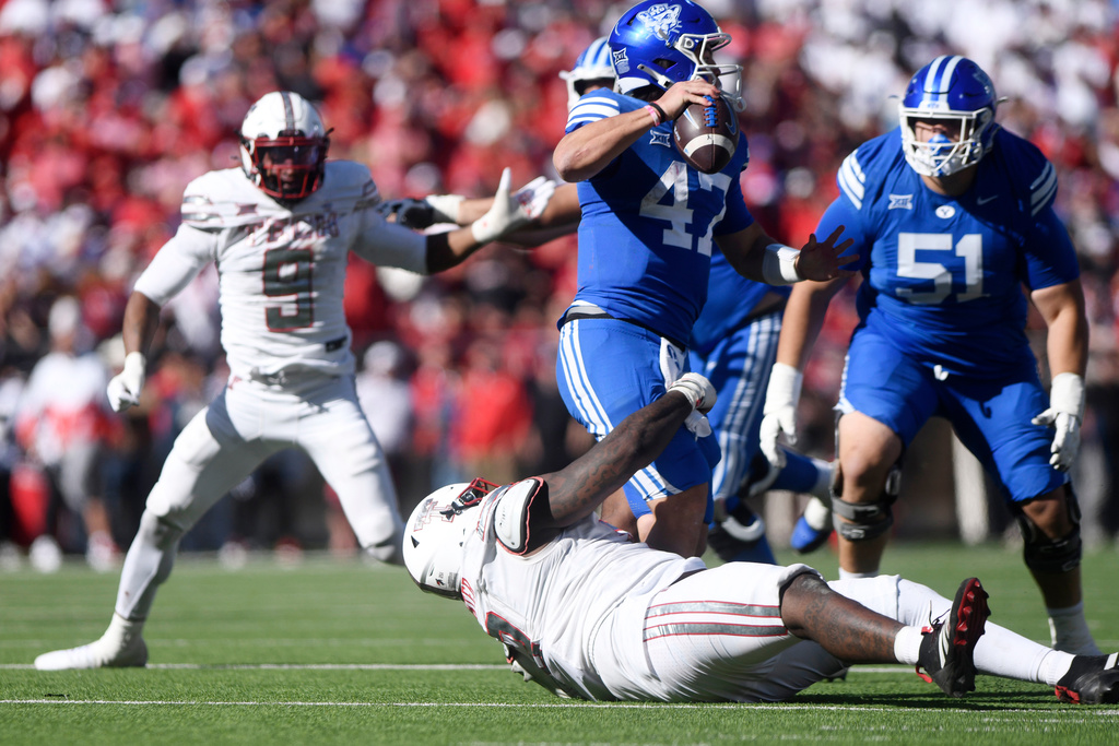 BYU quarterback Bear Bachmeier (47) is tackled by Texas Tech defensive lineman Lee Hunter (2) during the second half of an NCAA college football game, Saturday, Nov. 8, 2025, in Lubbock, Texas. (AP Photo/Annie Rice)