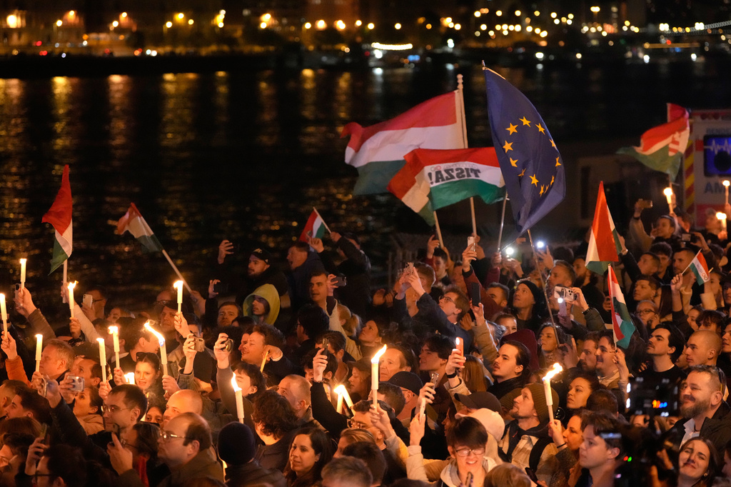 Supporters of Peter Magyar, the leader of the opposition Tisza party celebrate after a parliamentary election in Budapest, Hungary, Sunday, April 12, 2026. (AP Photo/Darko Bandic)