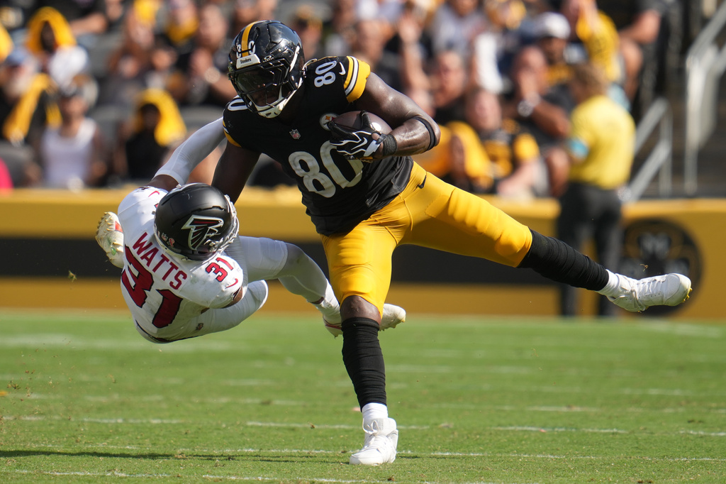 Pittsburgh Steelers tight end Darnell Washington (80) stiff arms Atlanta Falcons safety Xavier Watts (31) during an NFL football game, Sunday, Sept. 13, 2026, in Pittsburgh. (AP Photo/Gene J. Puskar)