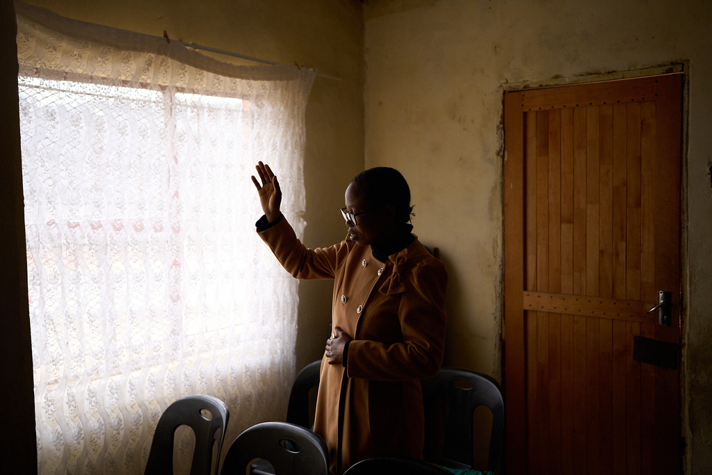FILE - A woman prays during a ceremony inside a church in Maseru, Lesotho, July 20, 2025. (AP Photo/Bram Janssen, File)