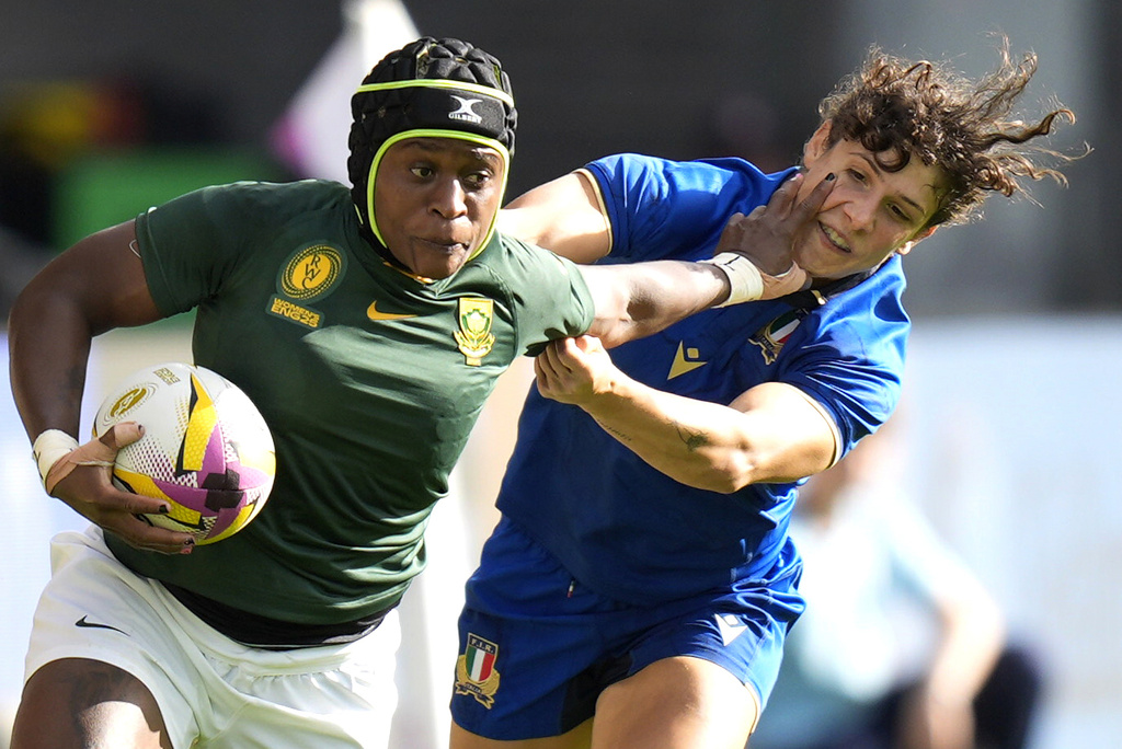 South Africa's Zintle Mpupha, left, attempts to get past Italy's Aura Muzzo during the Women's Rugby World Cup 2025 Pool D match between Italy and South Africa at at York Community Stadium, in York, England, Sunday Aug. 31, 2025. (Danny Lawson/PA via AP)
