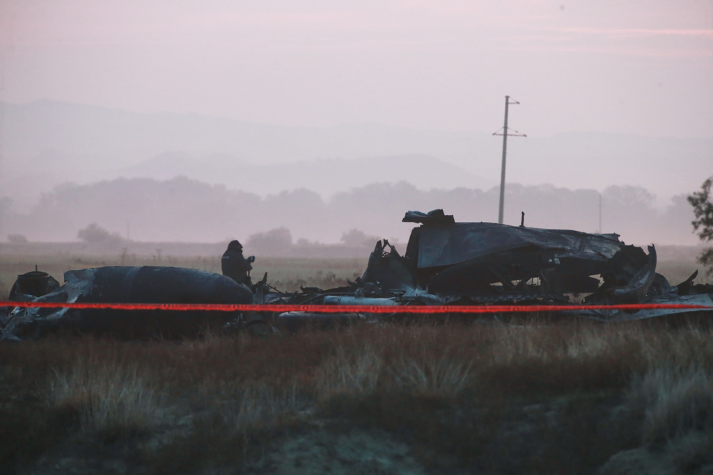 Debris is seen at a crash site of a Turkish military cargo plane in Georgia's Sighnaghi municipality, close to the Azerbaijani border on Wednesday, Nov. 12, 2025. (AP Photo/Zurab Tsertsvadze)