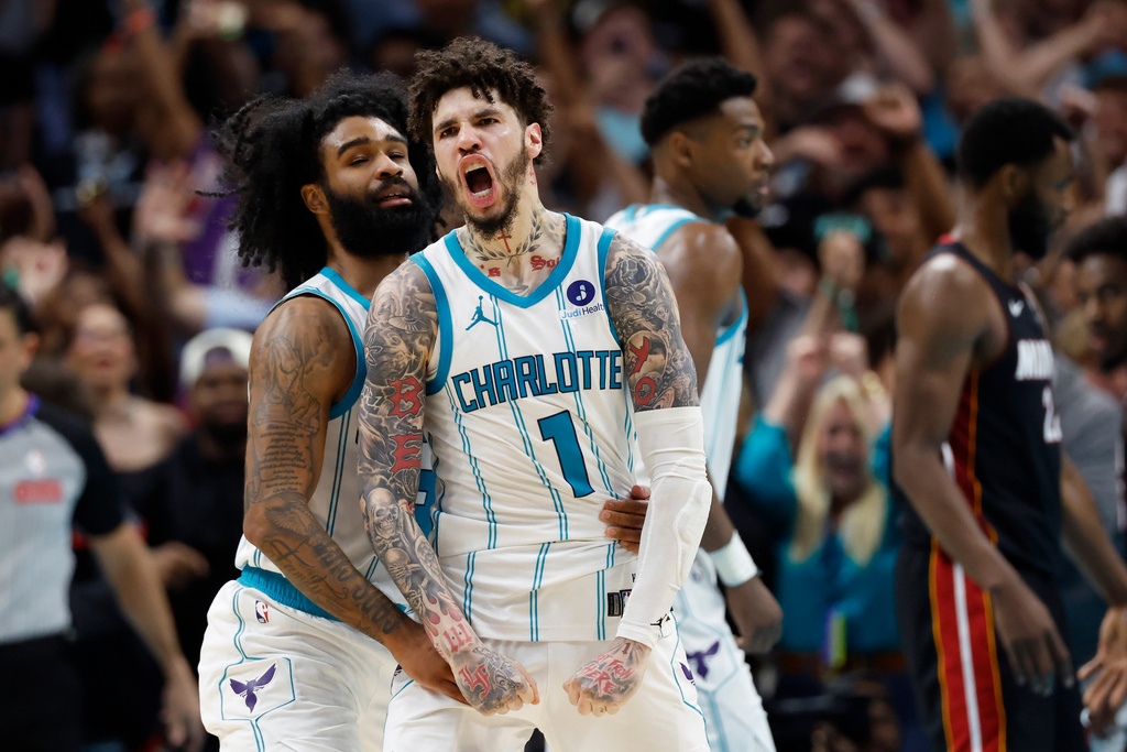 Charlotte Hornets guard LaMelo Ball (1) celebrates with guard Coby White after scoring against the Miami Heat during the second half of an NBA play-in tournament basketball game in Charlotte, N.C., Tuesday, April 14, 2026. (AP Photo/Nell Redmond)