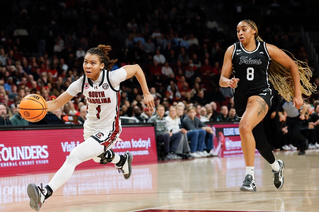 South Carolina guard Maddy McDaniel (1) drives to the basket ahead of Providence forward Nalani Kaysia during the second half of an NCAA college basketball game in Columbia, S.C., Sunday, Dec. 28, 2025. (AP Photo/Nell Redmond)