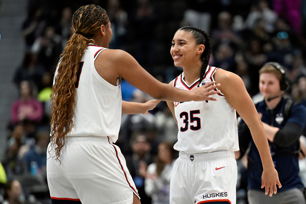 UConn forward Sarah Strong, left, talks with UConn guard Azzi Fudd, right, before tip off in an NCAA college basketball game against Georgetown, Thursday, Feb. 26, 2026, in Hartford, Conn. (AP Photo/Jessica Hill)