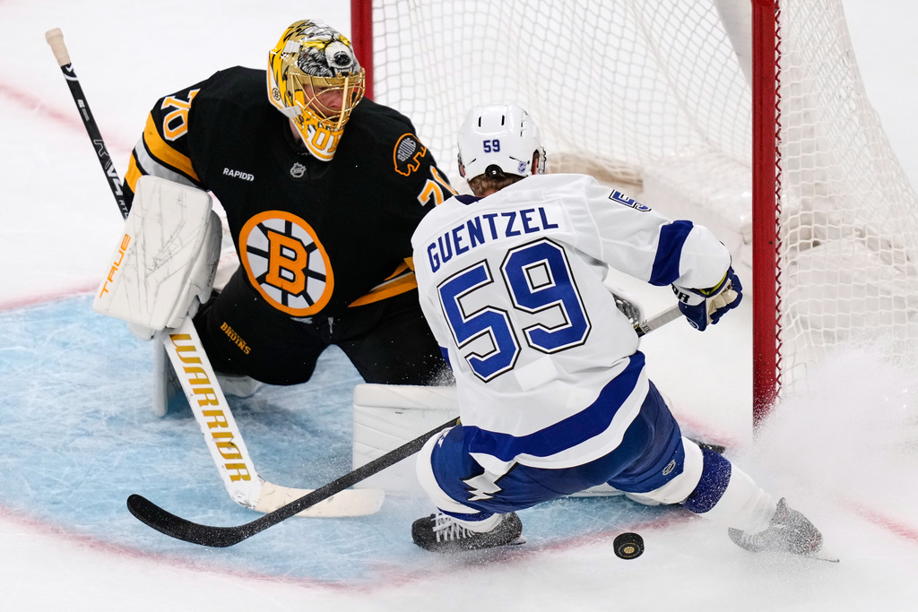 Boston Bruins goaltender Joonas Korpisalo (70) makes a save on a shot by Tampa Bay Lightning center Jake Guentzel (59) during the second period of an NHL hockey game, Monday, Oct. 13, 2025, in Boston. (AP Photo/Charles Krupa)