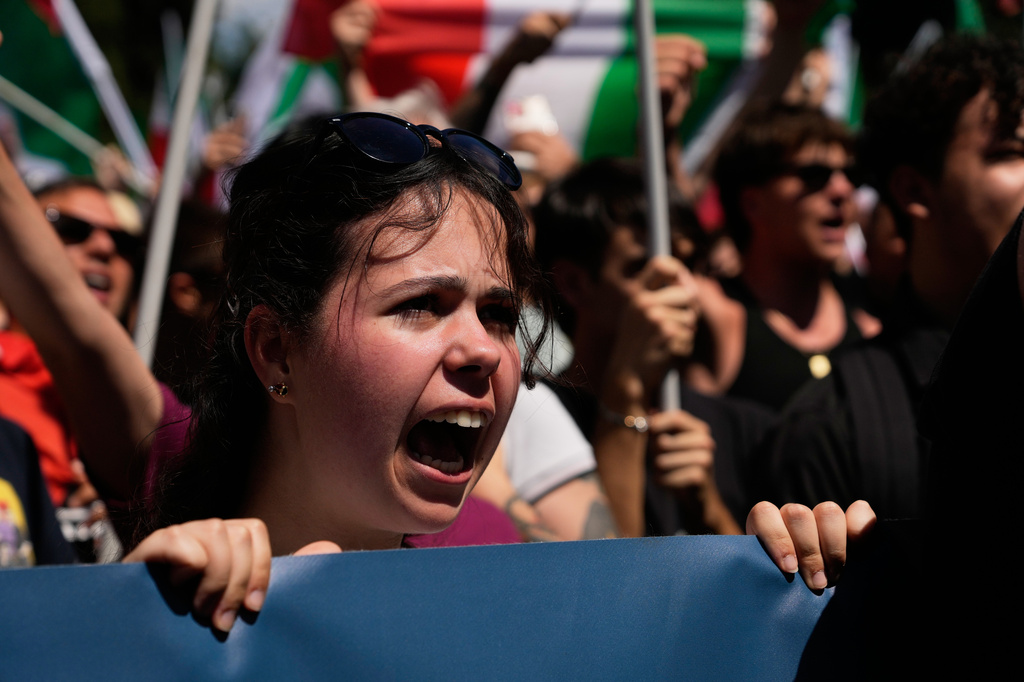 Demonstrators shout slogans as they gather during a protest organized by right-wing groups, calling for the repatriation of migrants, in Rome, Saturday, June 13, 2026. (AP Photo/Gregorio Borgia)