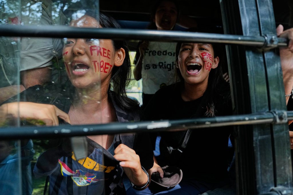 Exiled Tibetans shout slogans from a police vehicle after being detained during a protest outside the Chinese Embassy on China's National Day in New Delhi, India, Thursday, Oct. 1, 2026. (AP Photo/Manish Swarup)