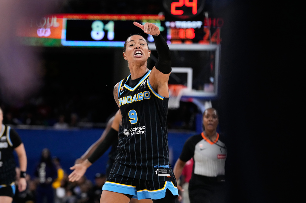 Chicago Sky guard Natasha Cloud argues with former NBA center Enes Kanter Freedom, right, during the second half of a WNBA basketball game against the Indiana Fever, Sunday, Aug. 23, 2026, in Chicago. (AP Photo/Nam Y. Huh)