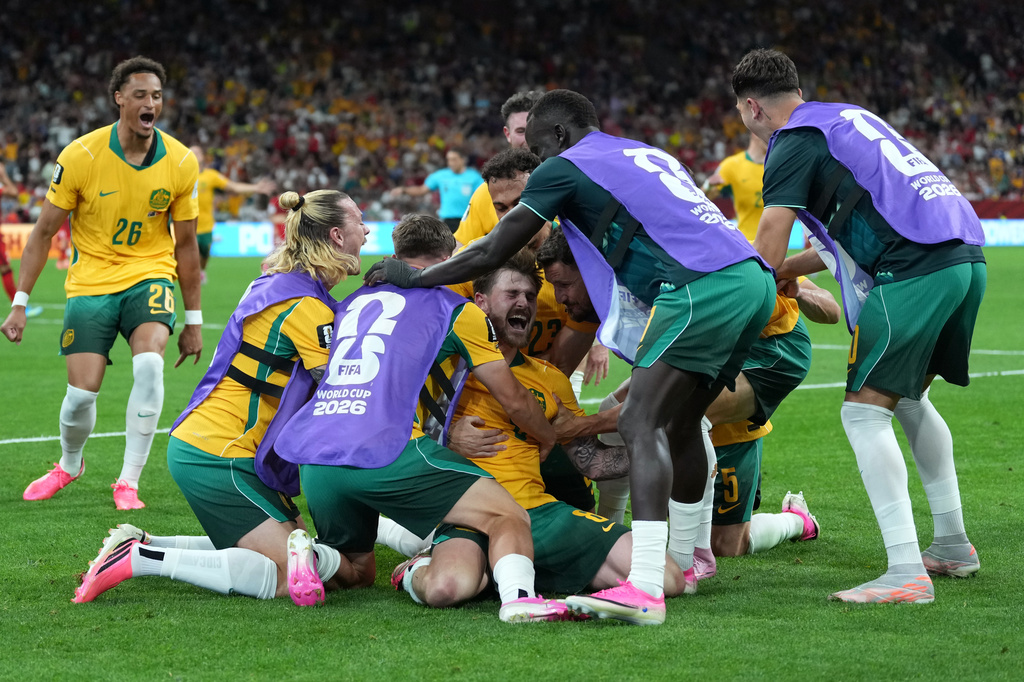 Australia's Connor Metcalfe, center, celebrates with teammates after scoring their second goal during the World Cup Group D soccer match between Australia and Turkey in Vancouver, British Columbia, Saturday, June 13, 2026. (AP Photo/Abbie Parr)