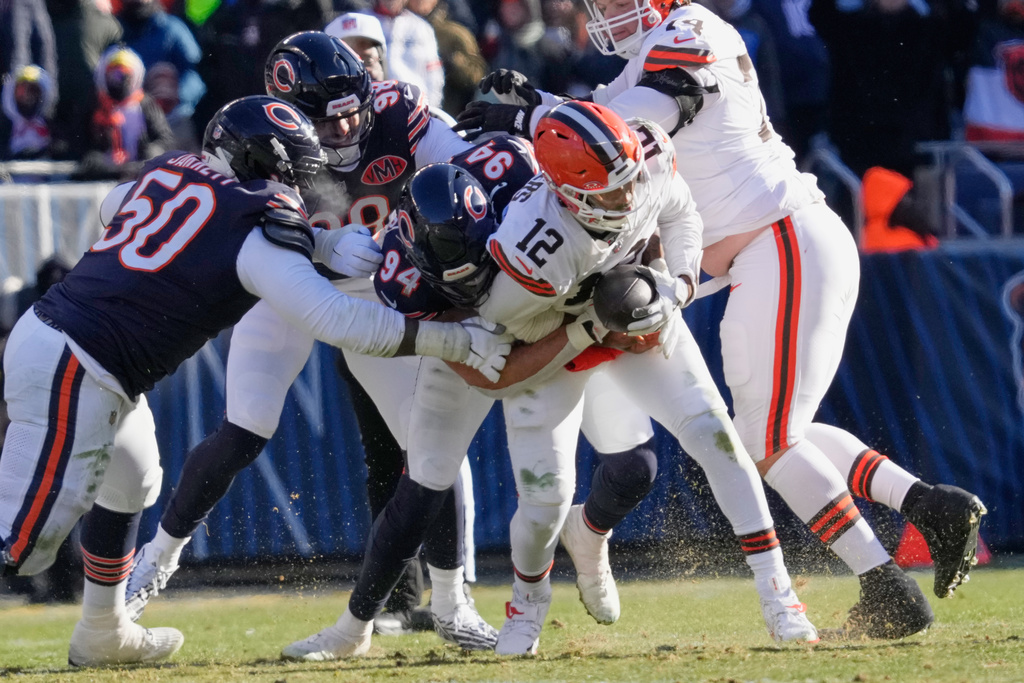 Chicago Bears defensive end Austin Booker (94) sacks Cleveland Browns quarterback Shedeur Sanders (12) in the first half of an NFL football game in Chicago, Sunday, Dec. 14, 2025. (AP Photo/Nam Y. Huh)